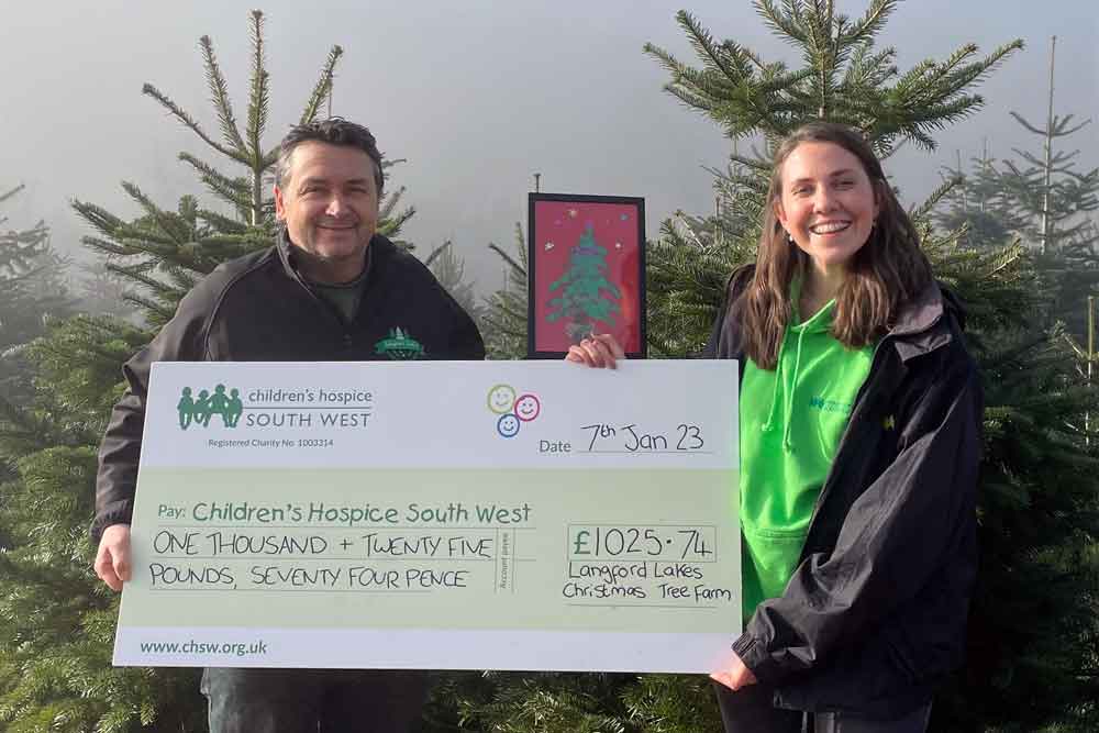 Nick Hendy from Langford Lakes Christmas Tree Farm donates a cheque for the money raised to Mary Gray, Area Fundraiser at Children’s Hospice South West.