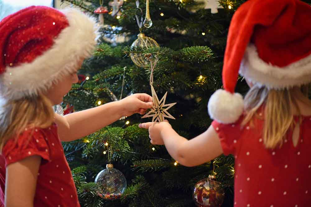 Children decorate a Christmas tree