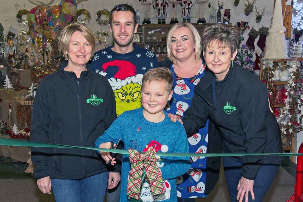 Finley Larcombe cuts the ribbon to open the Langford Lakes Christmas shop